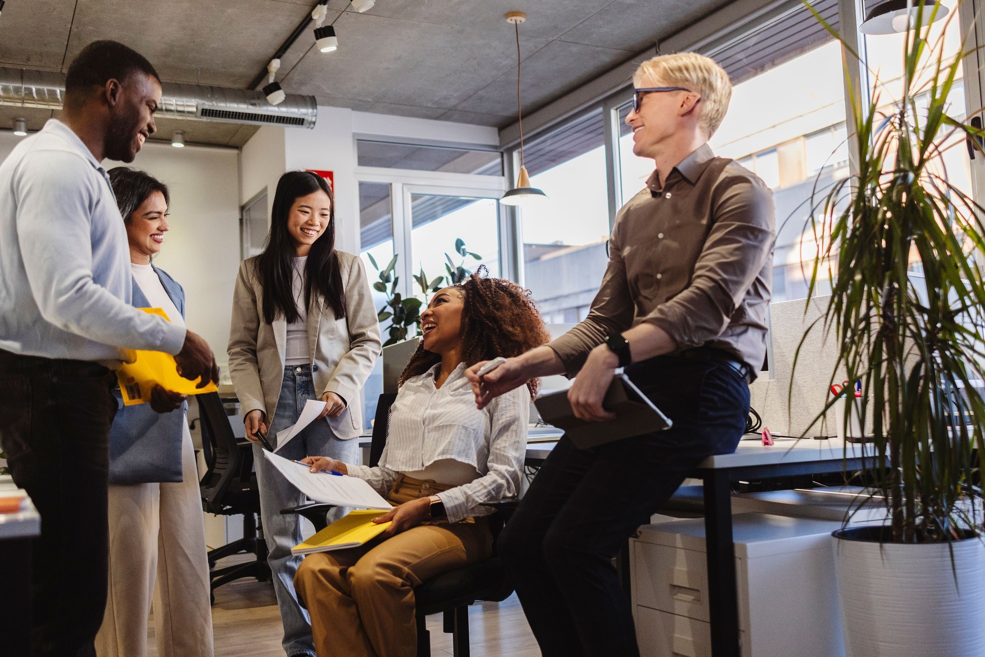 Diverse business team collaborating and sharing ideas in modern office